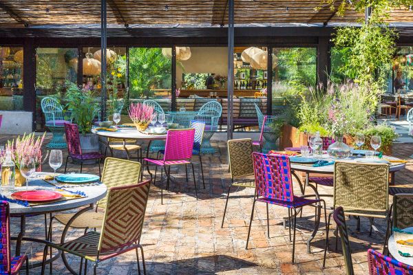 Esterno de Le Serre by Vivi, garden restaurant con tavoli colorati e atmosfera accogliente.