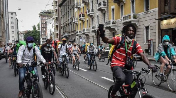 Contratto rider: gruppo di fattorini in bici a Milano. Lavoro, diritti.