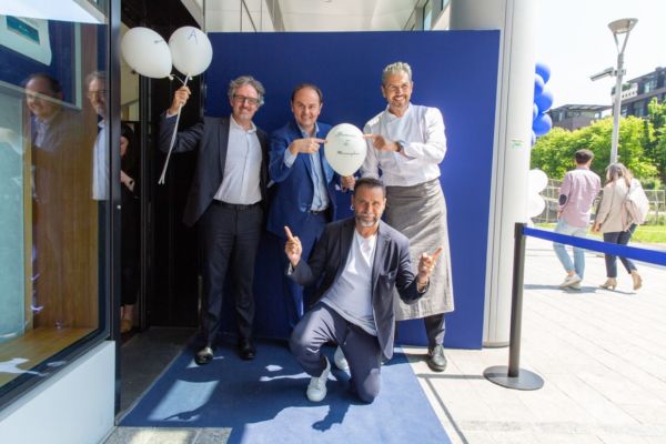 Andrea Baccuini e team celebrano Meraviglioso. Chef e imprenditori sorridenti all'evento. Nuova apertura ristorante.