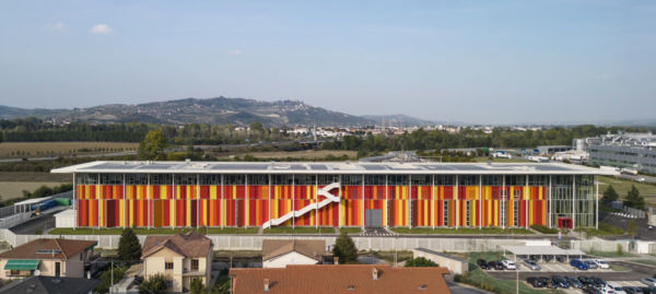 Ferrero apre ad Alba: polo innovazione tecnica. Edificio colorato con scala esterna.